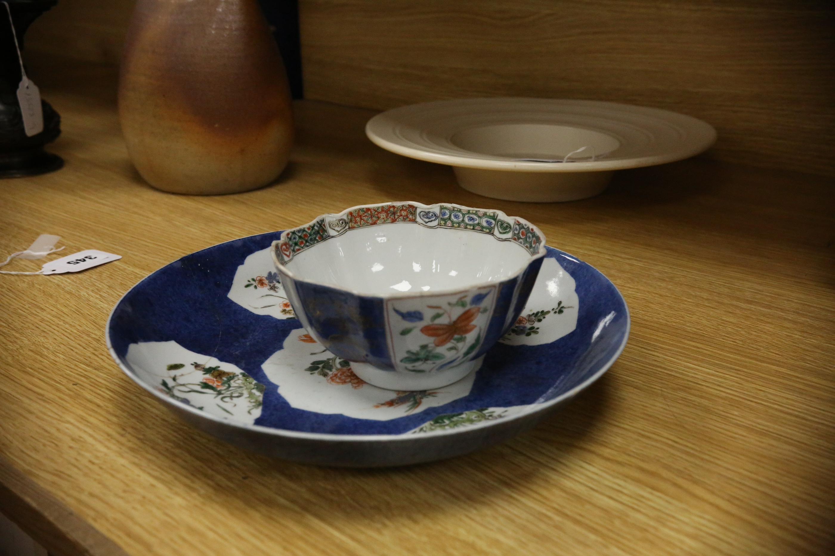 A Chinese famille verte powder blue ground bowl and a similar dish, both Kangxi period, 27.5cm diameter. Condition - dish poor, bowl fair